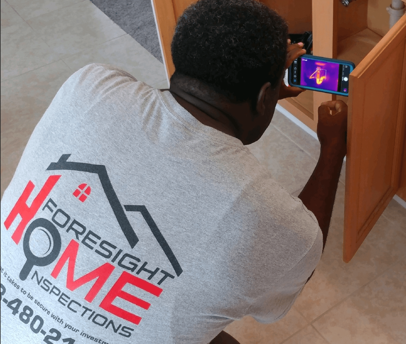 Infrared Thermal Imaging (FLIR) camera inspecting home electrical heat profile